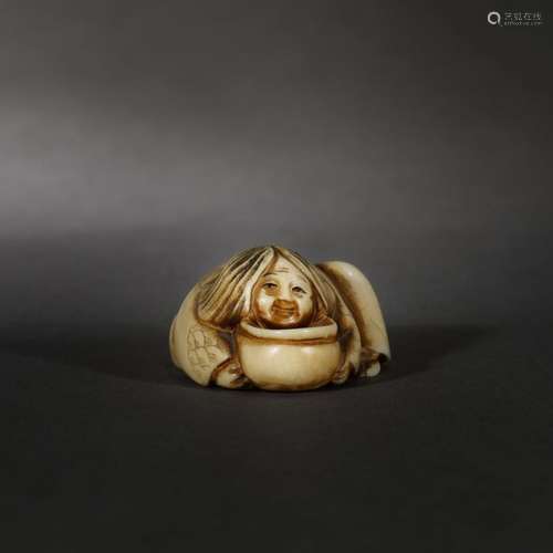 Ivory netsuke of a child warming up by a hibachi, …