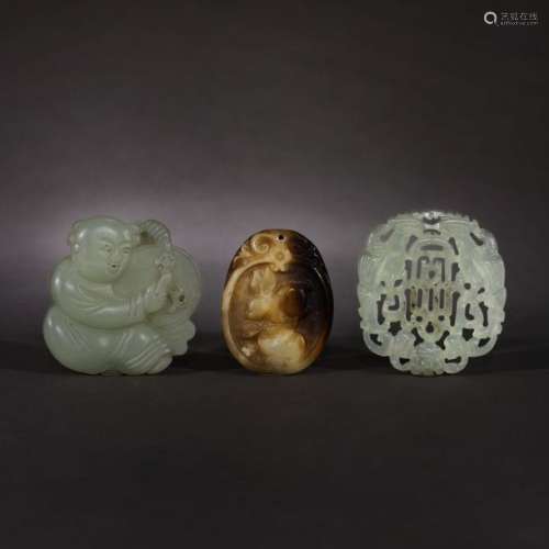 One jade and two serpentine pendants decorated wit…