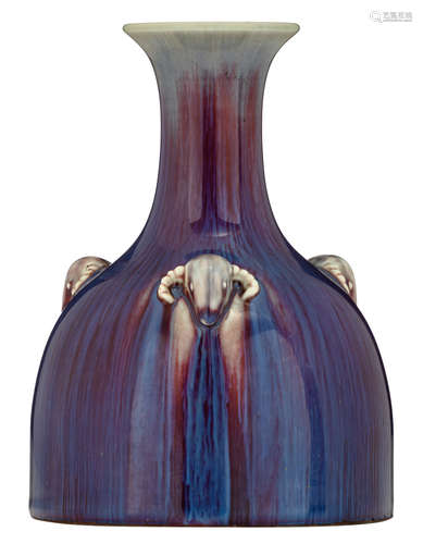 A Chinese flambé-glazed mallet shaped vase, covered in a deep purplish-red glaze, streaked in milky blue, the shoulder moulded with three ramheads, with an incised Yongzheng mark, H 20,5 cm 