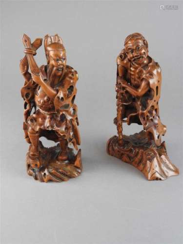 A pair of Chinese boxwood figures of an ascetic and warrior monk, each in standing pose and with