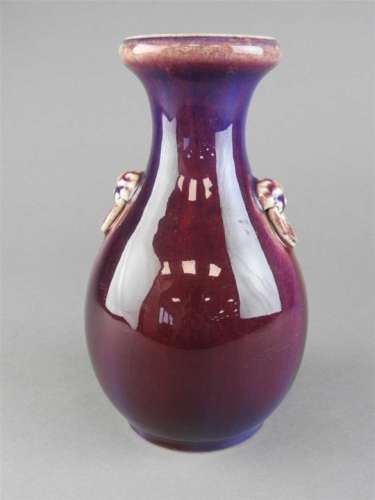 A Chinese flambe pear shaped vase, Qing Dynasty, 19 th century with lion mask ring handles and