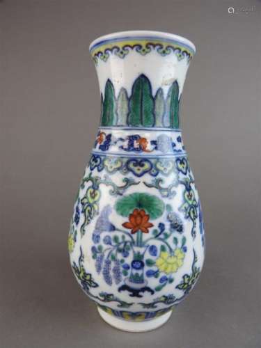 A Chinese doucai porcelain vase of pear shape decorated with a wide band of lotus flowers in vases