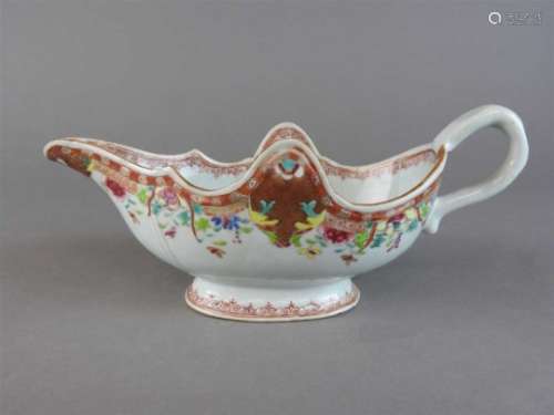 A Chinese famille rose porcelain sauce boat, Qianlong (1736-95), of a low oval form with a raised