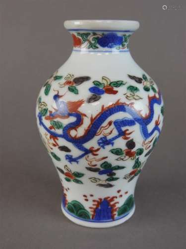 A Chinese wucai porcelain baluster vase, Wanli mark, the body decorated with underglaze blue, iron