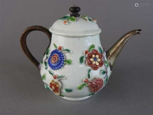 A Chinese famille rose porcelain florally encrusted teapot, Qing dynasty, early 18th century, now