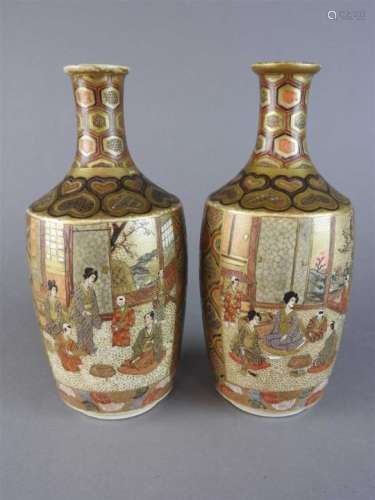 A pair of Japanese satsuma earthenware vases, Meiji/Taisho period, of bottle form with relief