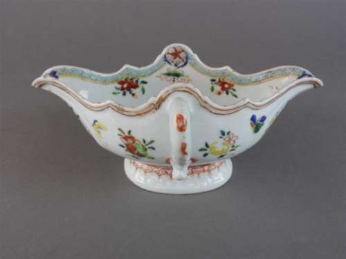 A Chinese porcelain famille rose twin handled sauce boat, Yongzheng (1723-35) of shaped oval form