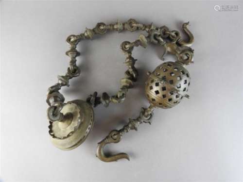 An Indian bronze temple bell, 19 th century, of oval form, containing six small bells within a