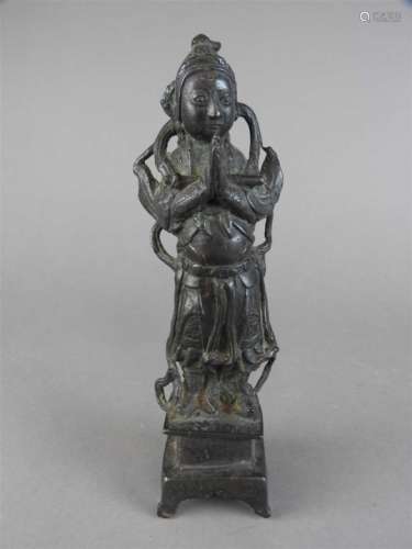 A Chinese bronze figure of standing deity, possibly Ming, with hands clasped in prayer and