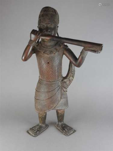 A large Benin bronze hollow cast of a horn blower, Nigeria, 19 th /20 th century, the figure