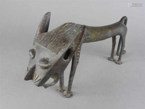 A Benin hollow cast figure of a stylised lion, similar to the previous lot, 47cm long, 20cm high