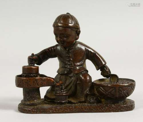 A SMALL JAPANESE BRONZE OF A SEATED BOY.  3ins long.