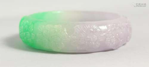 A GREEN AND LILAC JADE BANGLE.  3ins diameter.