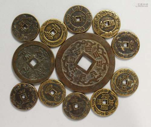 TWELVE CHINESE BRONZE COINS.  Various Sizes.