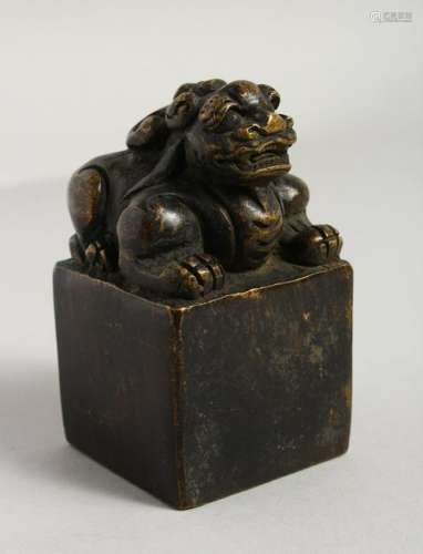 A BRONZE SQUARE SHAPE FO DOG SEAL.  4ins high.