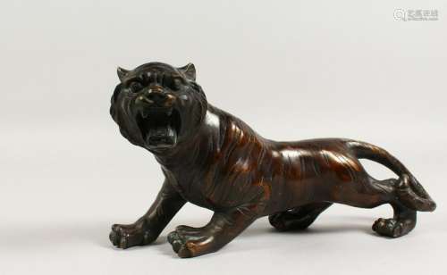 A JAPANESE BRONZE MODEL OF A TIGER.  12ins long.