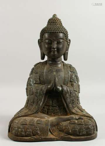 A LARGE CAST BRONZE MODEL OF A SEATED BUDDHA.  16ins