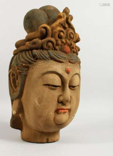 A CARVED AND PAINTED WOOD HEAD OF AN EASTERN FEMALE