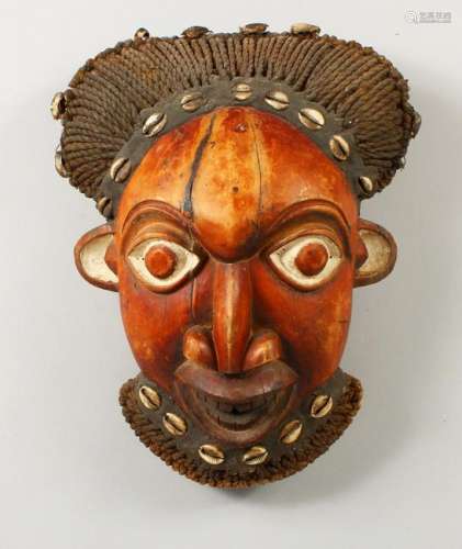 A CARVED AND PAINTED AFRICAN TRIBAL MASK, with plaited