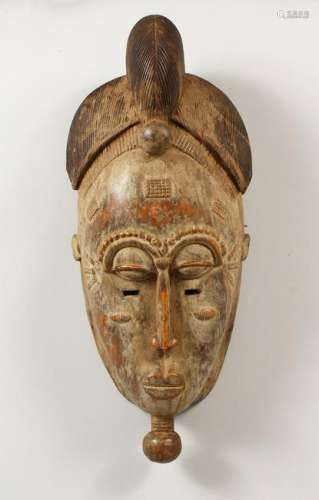 A WELL CARVED AFRICAN TRIBAL MASK.  17.5ins high.