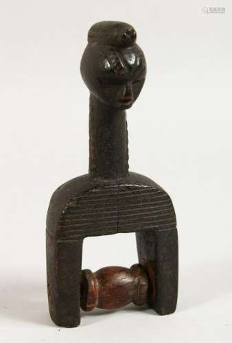 AN AFRICAN CARVED WOOD FIGURAL PULLEY.  6.5ins high.