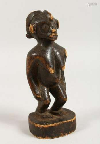 AN AFRICAN CARVED WOOD FIGURE OF A WOMAN.  6.5ins high.