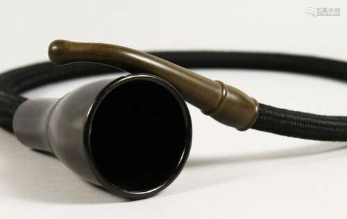 AN EARLY BAKELITE HEARING AID.  44ins long.