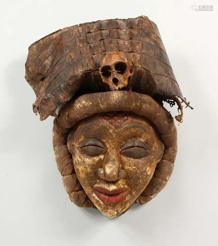 A CARVED AND PAINTED TRIBAL MASK, of a lady with