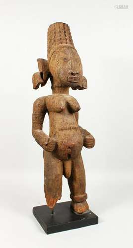 A LARGE CARVED WOOD AND PAINTED TRIBAL FIGURE, of a