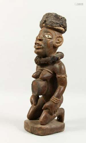 A CARVED WOOD AFRICAN FIGURE, a kneeling female nude