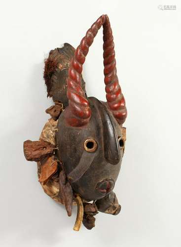 A GOOD CARVED AND PAINTED WOOD MASK, with red painted