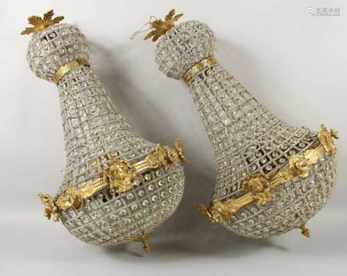 A PAIR OF BRASS AND CUT GLASS CHANDELIERS.  30ins high.