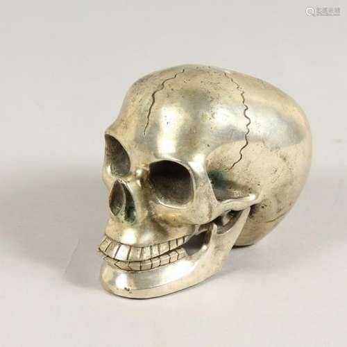 A SILVER PLATED MODEL OF A SKULL.  5ins long.