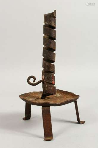 AN EARLY WROUGHT IRON CANDLESTICK.  9.5ins high.
