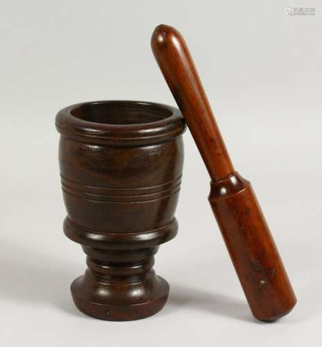 A 19TH CENTURY YEW WOOD PESTLE AND LIGNUM VITAE MORTAR.