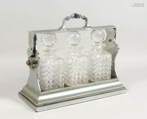 A LARGE TANTALUS, with three cut glass whisky decanters