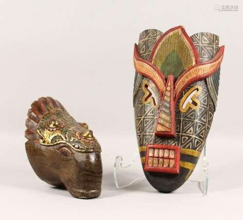 TWO CARVED WOOD AND PAINTED MASKS, one tribal style,