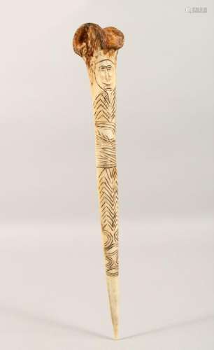 A CARVED BONE DAGGER, with incised decoration.