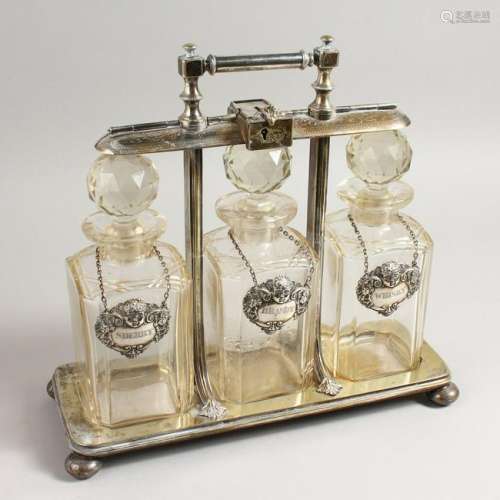 A GOOD LATE VICTORIAN TANTALUS, with patent hinged