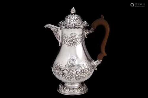 A British Silver Tea Pot with Carved Wood Handle