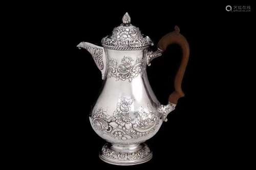 A British Silver Tea Pot with Carved Wood Handle