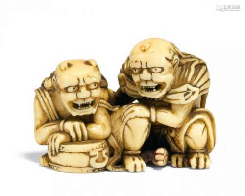 NETSUKE: TWO ONI WITH DRUM. Japan. 18th c. Ivory, carved and with engravings stained [...]