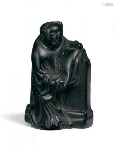 NETSUKE: KANZAN WITH SCROLL LEANING AGAINST A TSUITATE. Japan. 19th c. Ebony. Height [...]