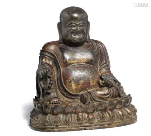 A Chinese patinated bronze Budai seated on a double lotus throne. Late Ming-Early [...]