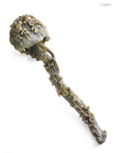 A Chinese Ruyi scepter of greenish jade richly carved with prunus in blossom. Late [...]