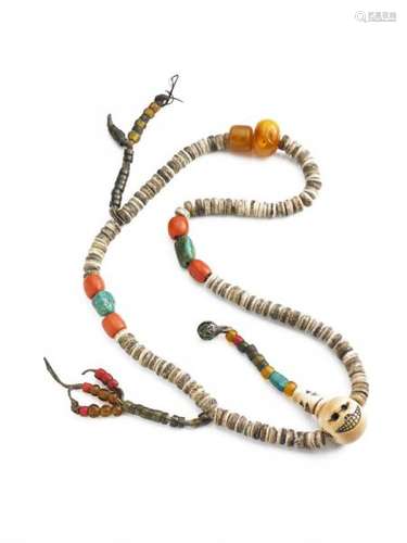 A Tibetan Tantric mala of bone discs, coral, amber and turquoise beads, with a large [...]