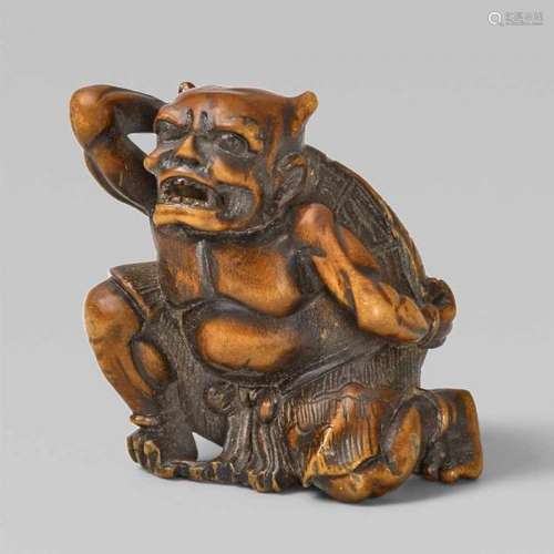 A boxwood netsuke of an oni on setsubun. 19th century.Squatting, holding a large [...]