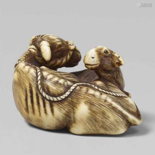 An ivory netsuke of an ox with a calf. Early 19th centuryRecumbent, its head turned [...]