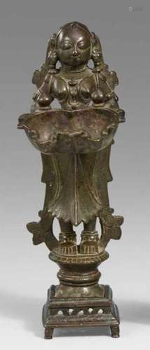 A bronze oil lamp of dipa lakshmi type. 18th/19th centuryIn three parts, the goddess [...]