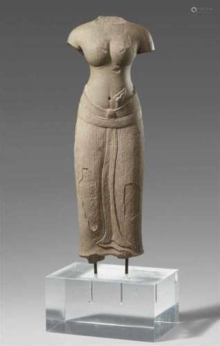 A Baphuon style grey sandstone torso of a female deity. Cambodia. Angkor. 11th [...]